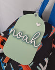 Colorful bag with a green tag featuring the name 'noah' on a white background